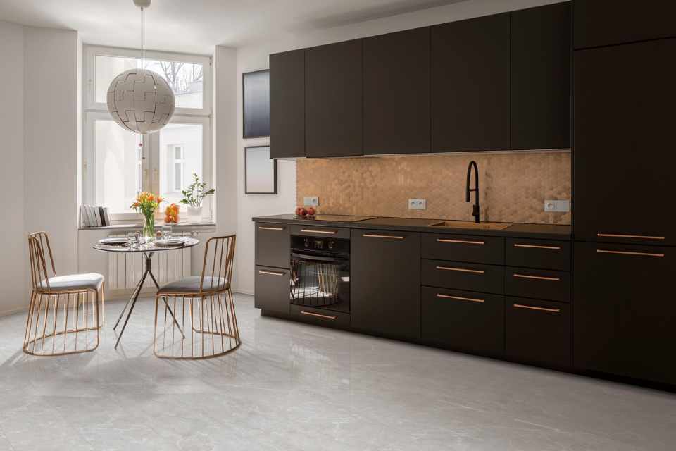 stone-look luxury vinyl in modern industrial kitchen with gold finishes